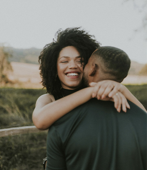 Woman smiling and hugging her partner, represents how you can move forward with the support of an EMDR therapist in Montclair, NJ.