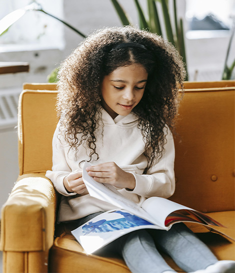 Child looking through a book, represents how executive functioning coaching in NJ or NYC can help you achieve meaningful results and regain control.