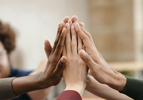 Hands together, represents collaboration, respect, and compassion that are central to our work at Evolve Psychological Services.