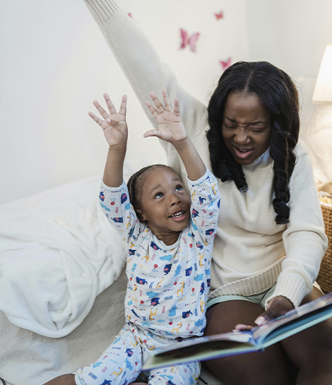 Mother reading a bed time story to her child, represents how working with a parent coach can help you feel closer to your child.